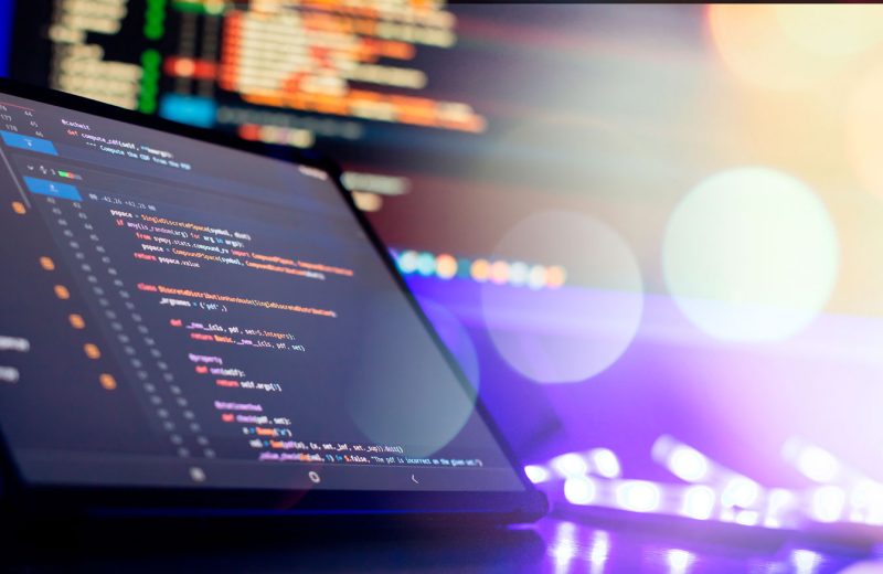 Laptop with code editor on screen